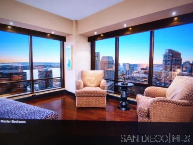 a living room with furniture and a floor to ceiling window