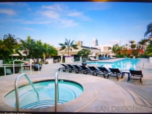 a view of a swimming pool with outdoor seating