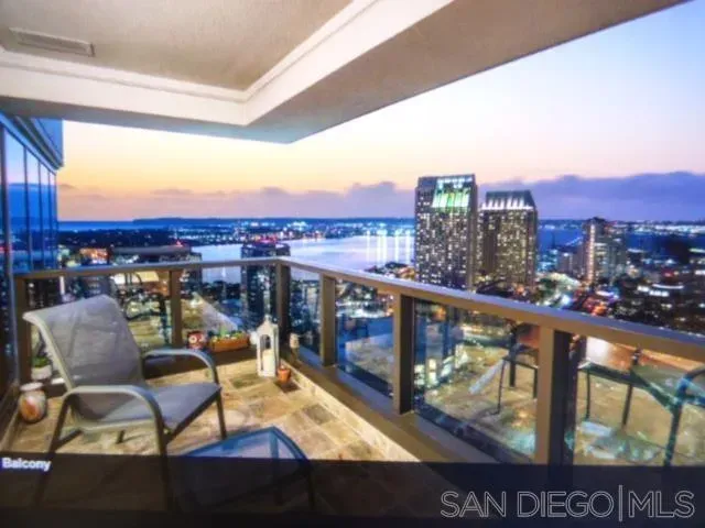 a view of a chairs and table in the balcony