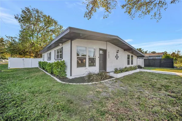 a view of a house with a backyard