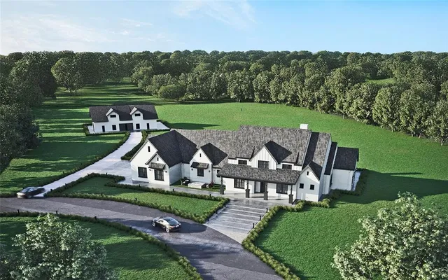 an aerial view of a house with big yard