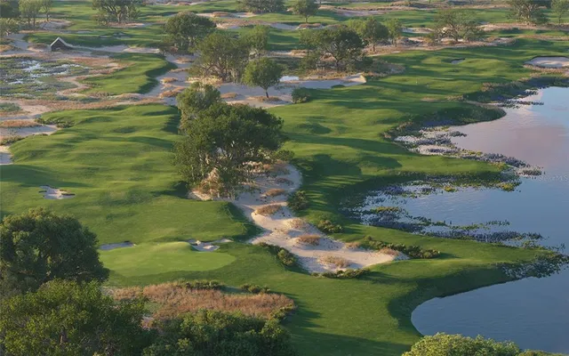 a view of a golf course of a lake