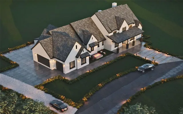 an aerial view of a house with a yard basket ball court