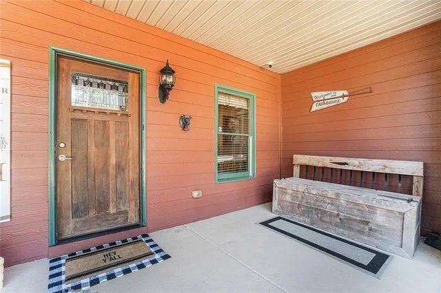 a kitchen with stainless steel appliances granite countertop a refrigerator a stove top oven a sink dishwasher and white cabinets with wooden floor