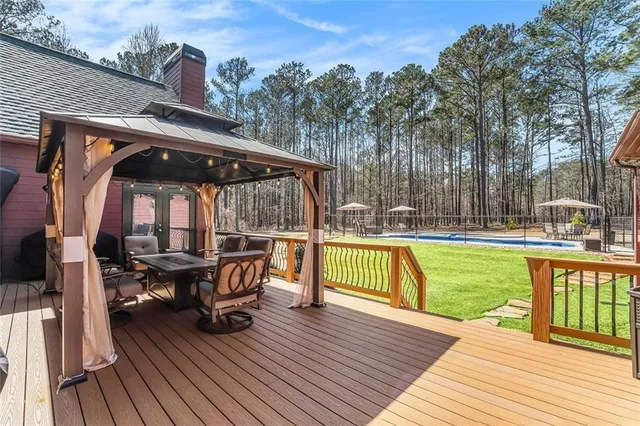 a living room with patio furniture and a flat screen tv