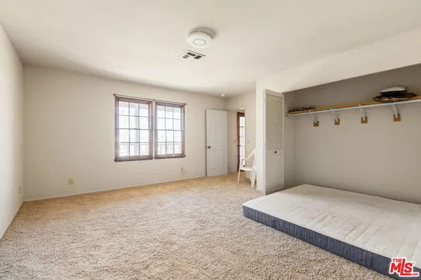 a big room with windows and closet