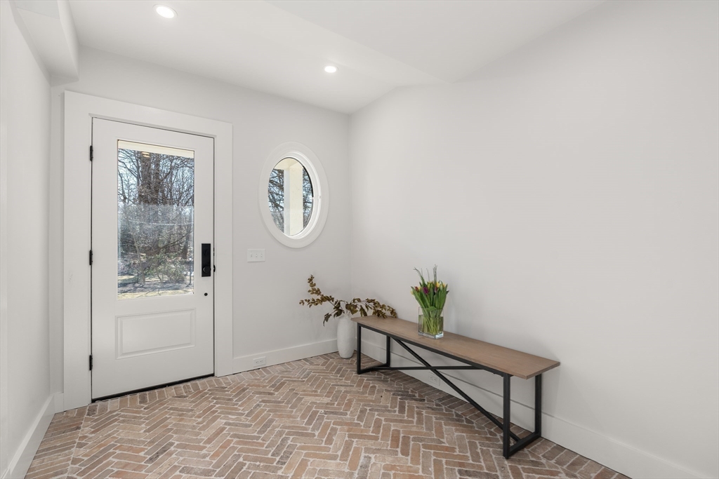 45 Islington Road Newton, MA 02466 - Photo 20 of 41 a view of a hallway with paintings on the wall