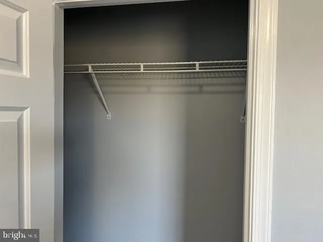 a view of a room with wooden floor and window