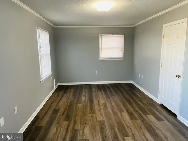 a view of a room with wooden floor and staircase