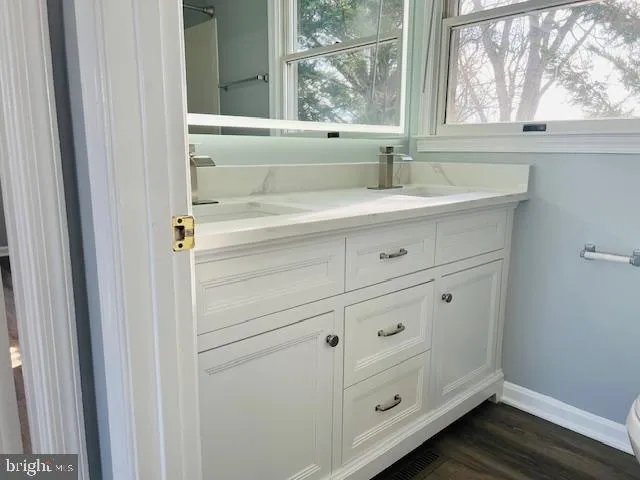 a bathroom with a sink and a window