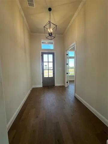 a view of a livingroom with a fireplace a ceiling fan and windows