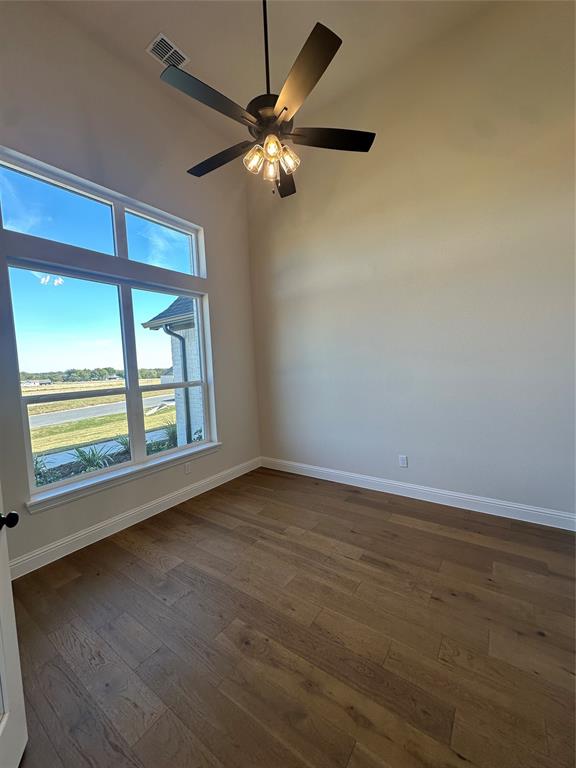 108 Blackstar Lane Decatur, TX 76234 - Photo 7 of 37 a view of an empty room with wooden floor and a window