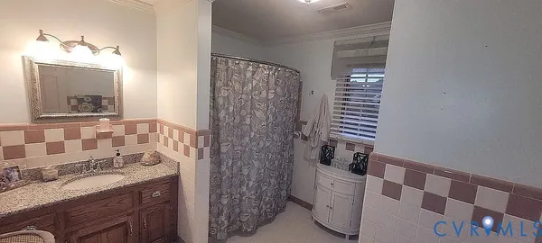 a bathroom with a tub sink and mirror