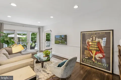 a living room with furniture and wall paintings