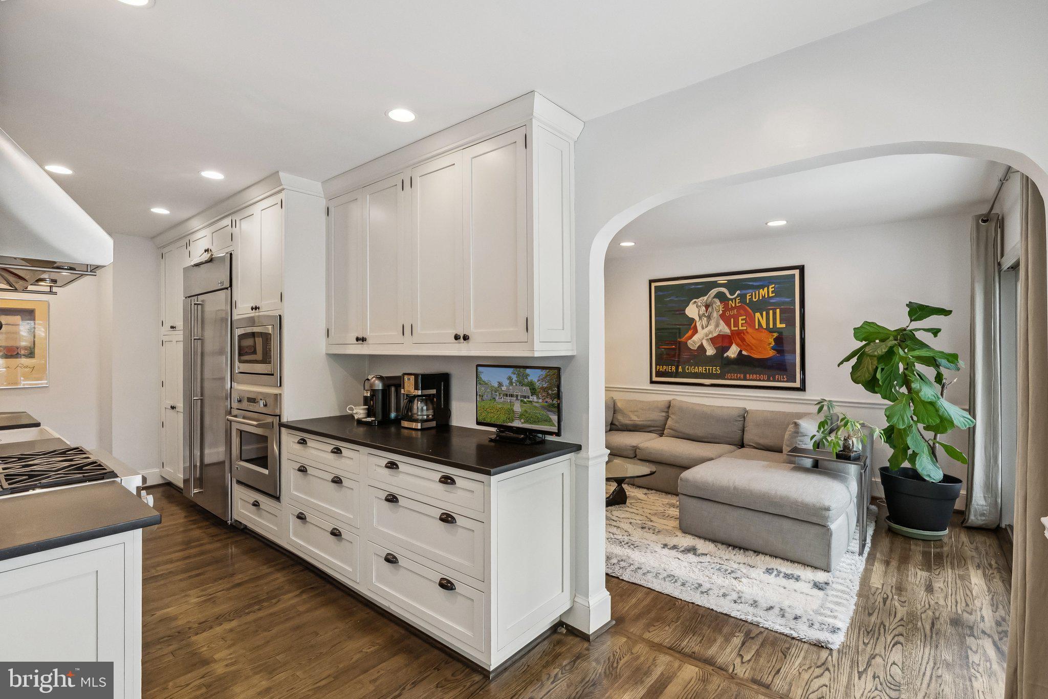 8109 Custer Road Bethesda, MD 20814 - Photo 14 of 54 a living room with furniture and a flat screen tv