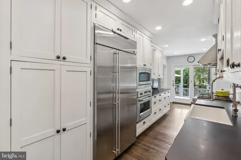 a kitchen with stainless steel appliances a refrigerator and a sink