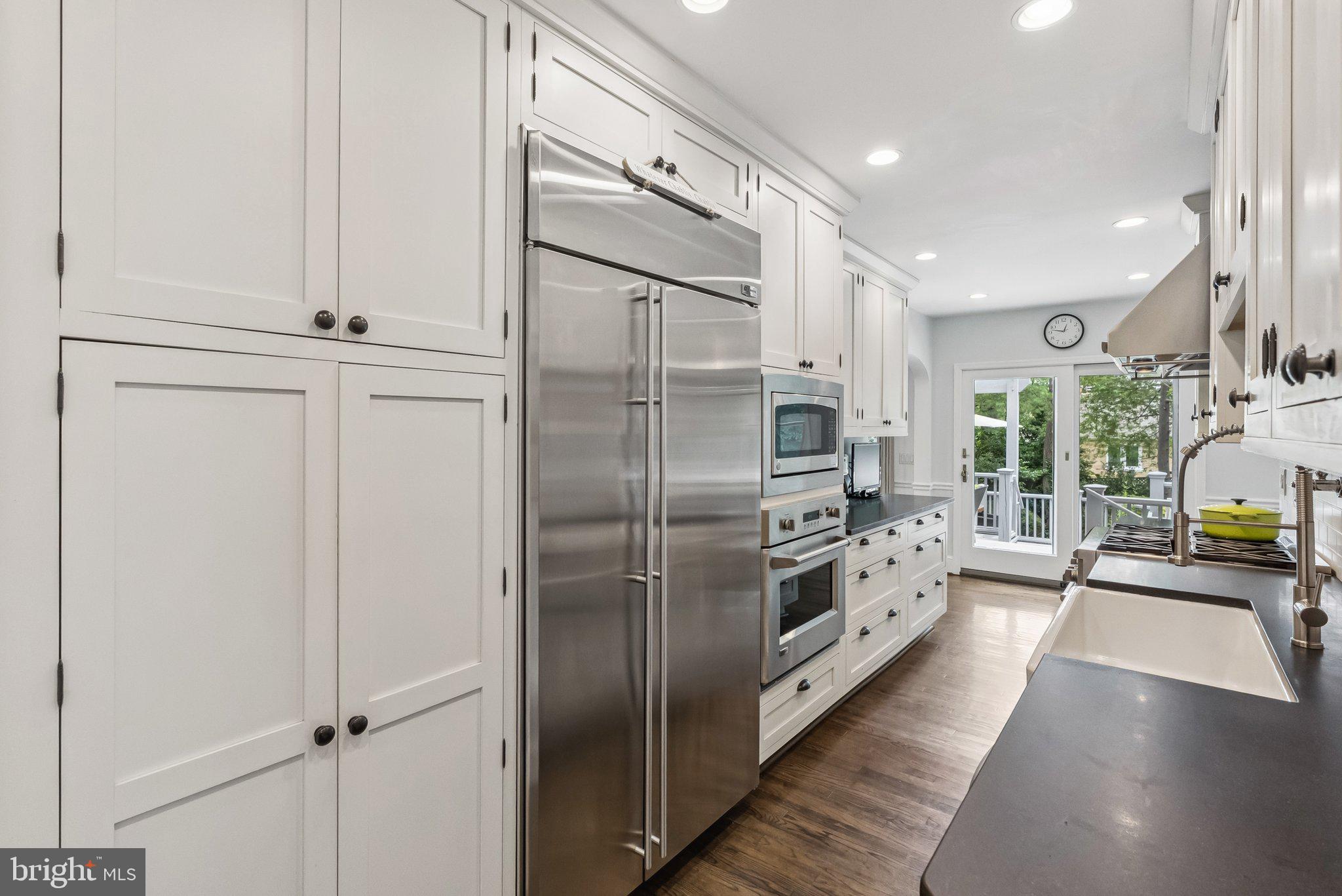 8109 Custer Road Bethesda, MD 20814 - Photo 16 of 54 a kitchen with stainless steel appliances a refrigerator and a sink