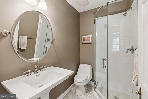 a bathroom with a toilet sink and shower