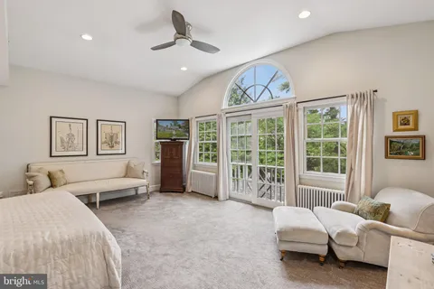 a bedroom with a bed couch and window