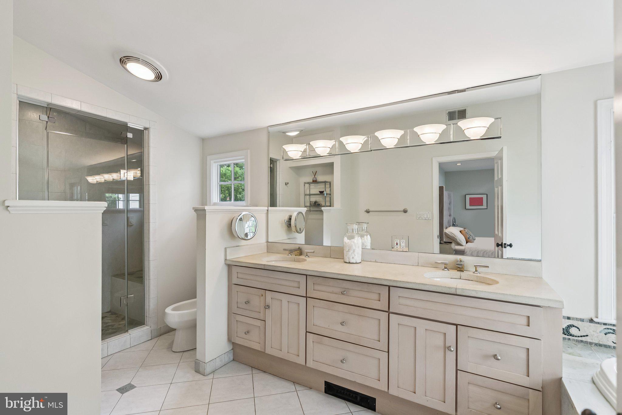 8109 Custer Road Bethesda, MD 20814 - Photo 26 of 54 a spacious bathroom with a granite countertop sink mirror and toilet