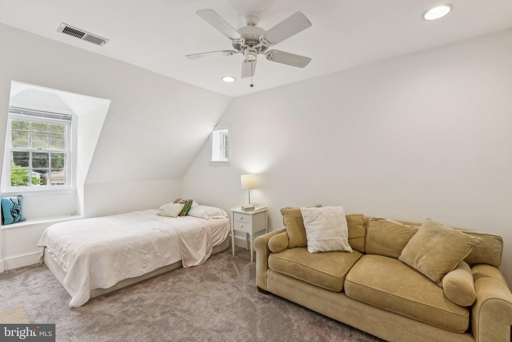 8109 Custer Road Bethesda, MD 20814 - Photo 28 of 54 a bedroom with a bed couch and window