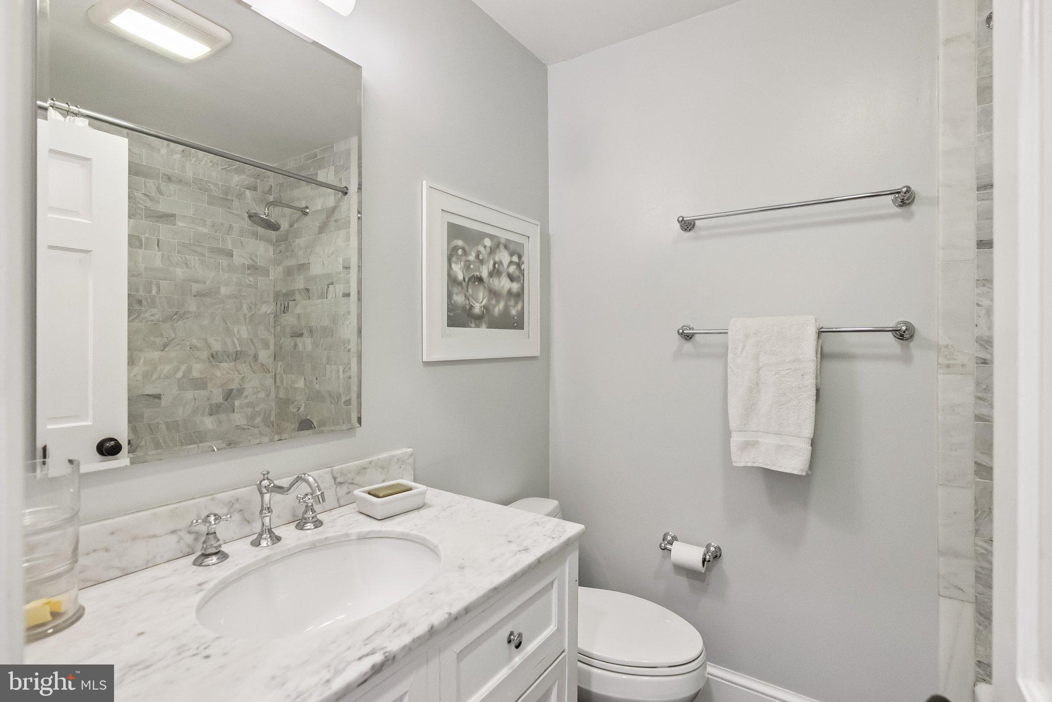8109 Custer Road Bethesda, MD 20814 - Photo 30 of 54 a bathroom with a sink toilet and shower