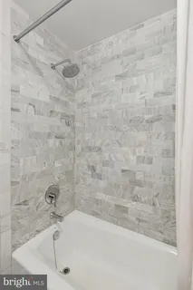 a spacious bedroom with a bed and a window