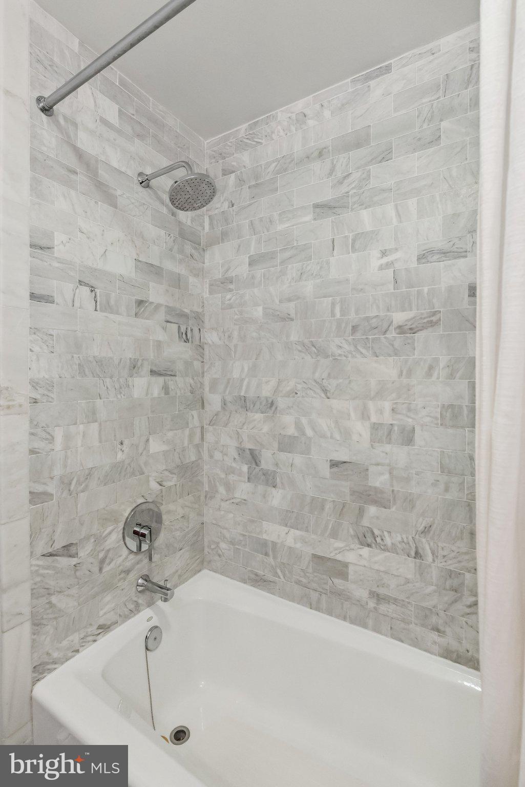 8109 Custer Road Bethesda, MD 20814 - Photo 31 of 54 a bathroom with a bathtub