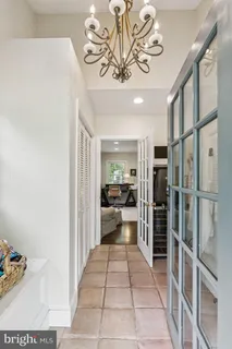a living room with a couch and a chandelier