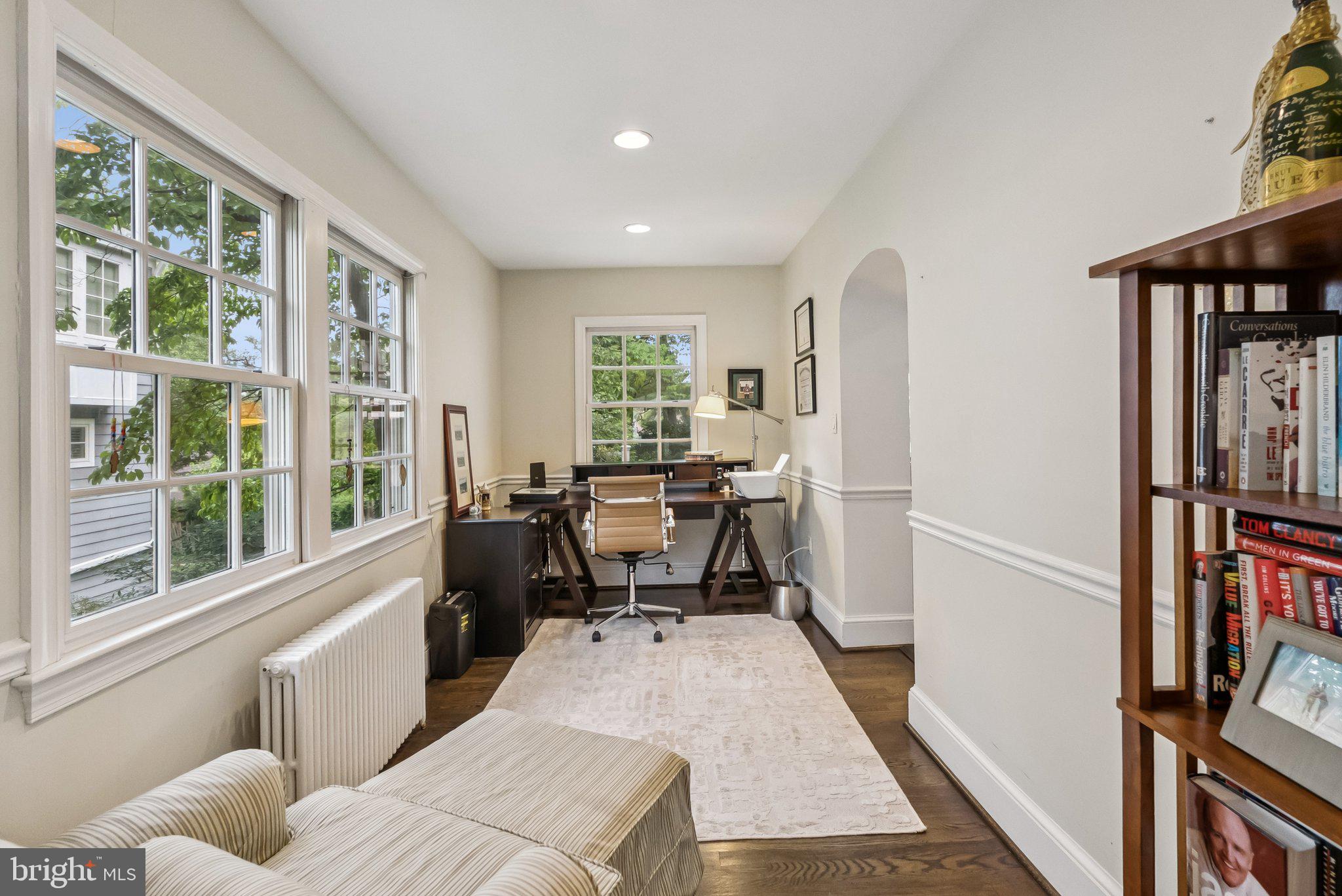 8109 Custer Road Bethesda, MD 20814 - Photo 39 of 54 a living room with furniture a window and a book shelf