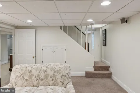 a bedroom with a large bed rug and wall painting