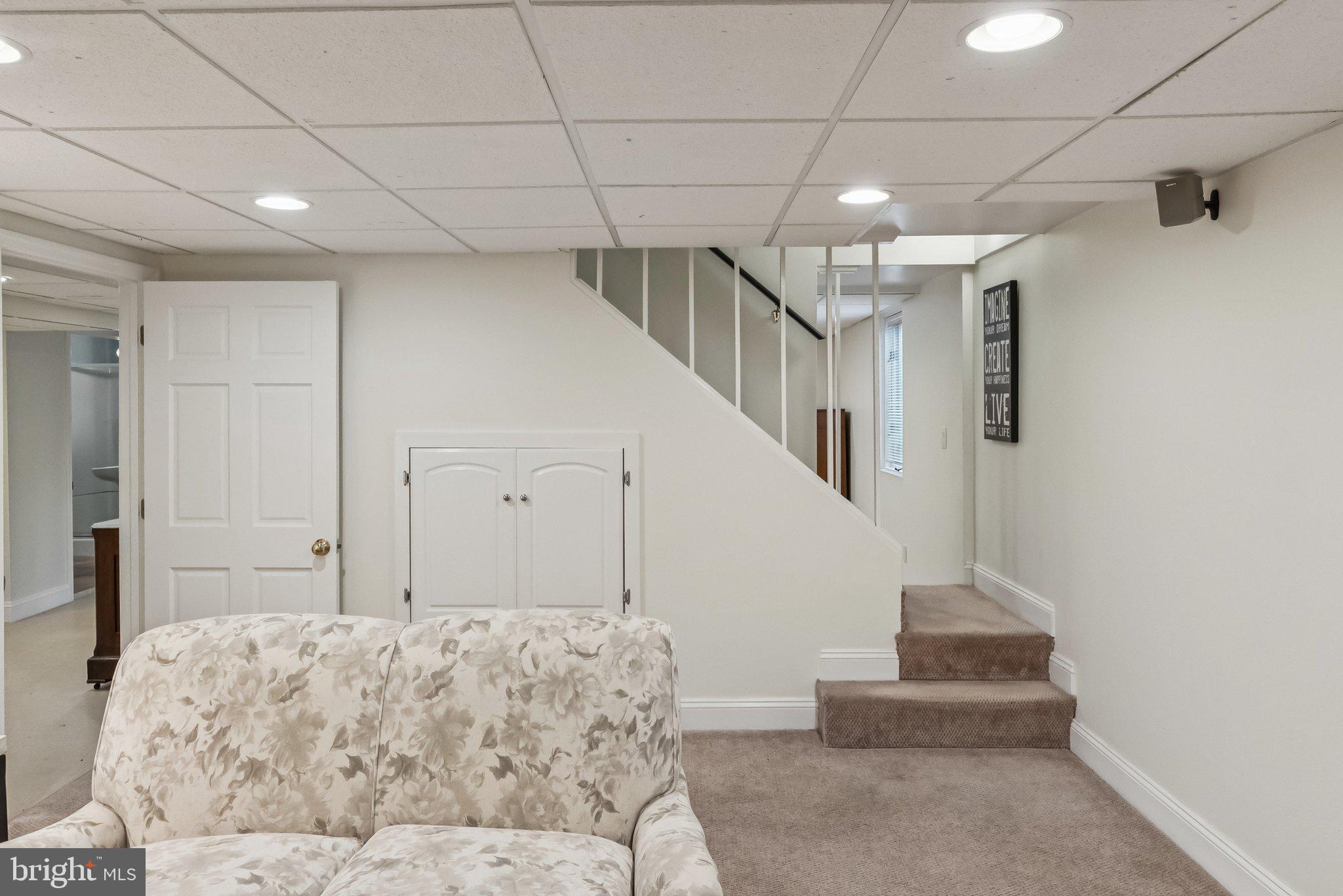 8109 Custer Road Bethesda, MD 20814 - Photo 40 of 54 a living room with a couch and a chandelier