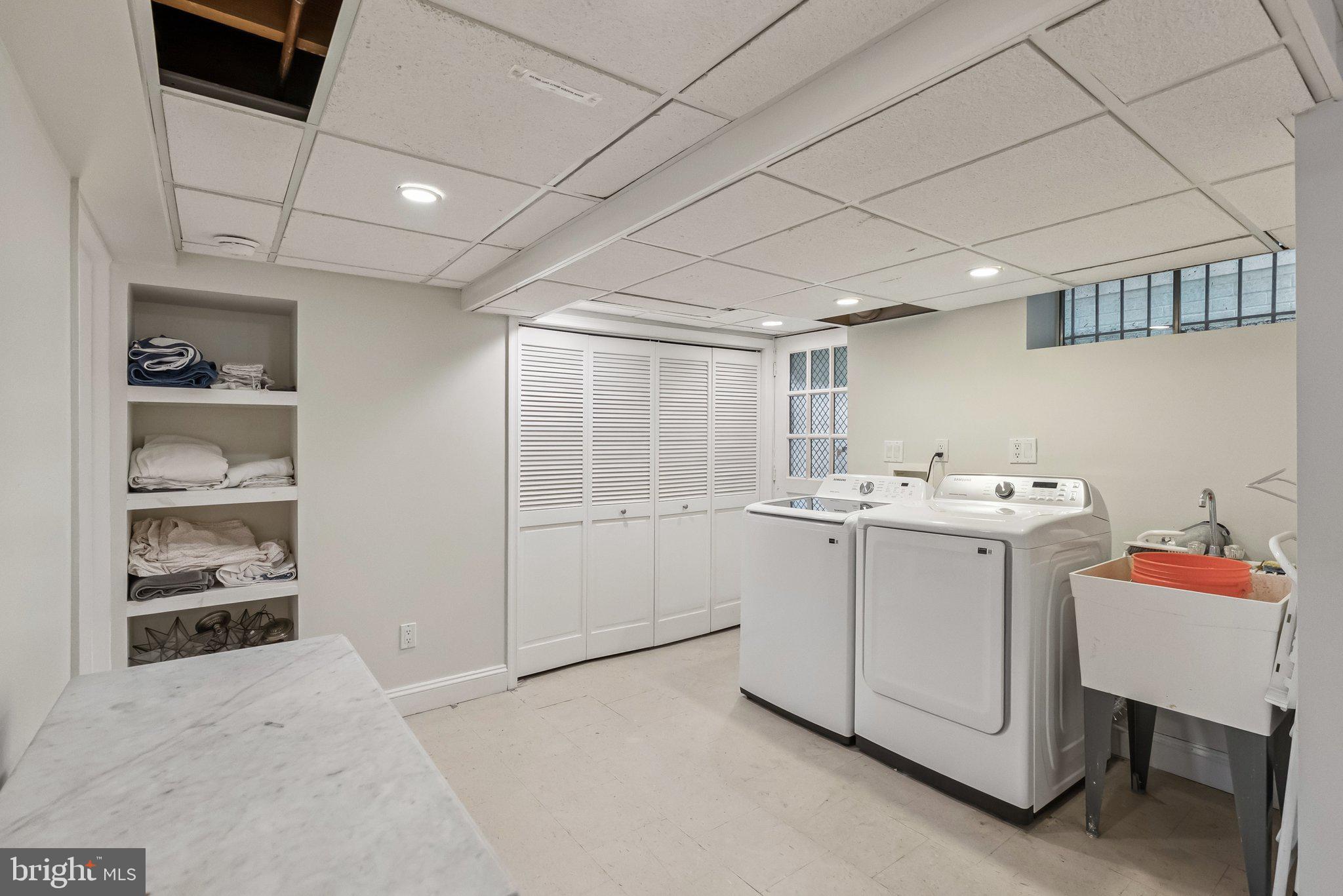 8109 Custer Road Bethesda, MD 20814 - Photo 44 of 54 a utility room with dryer and washer