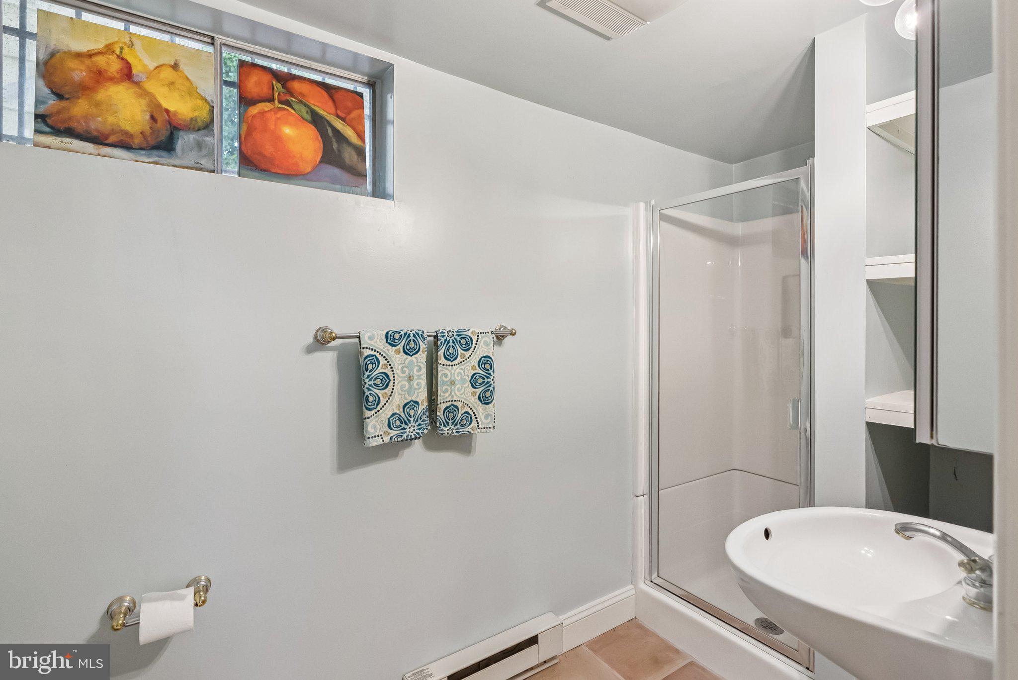 8109 Custer Road Bethesda, MD 20814 - Photo 45 of 54 a bathroom with a toilet a sink and mirror