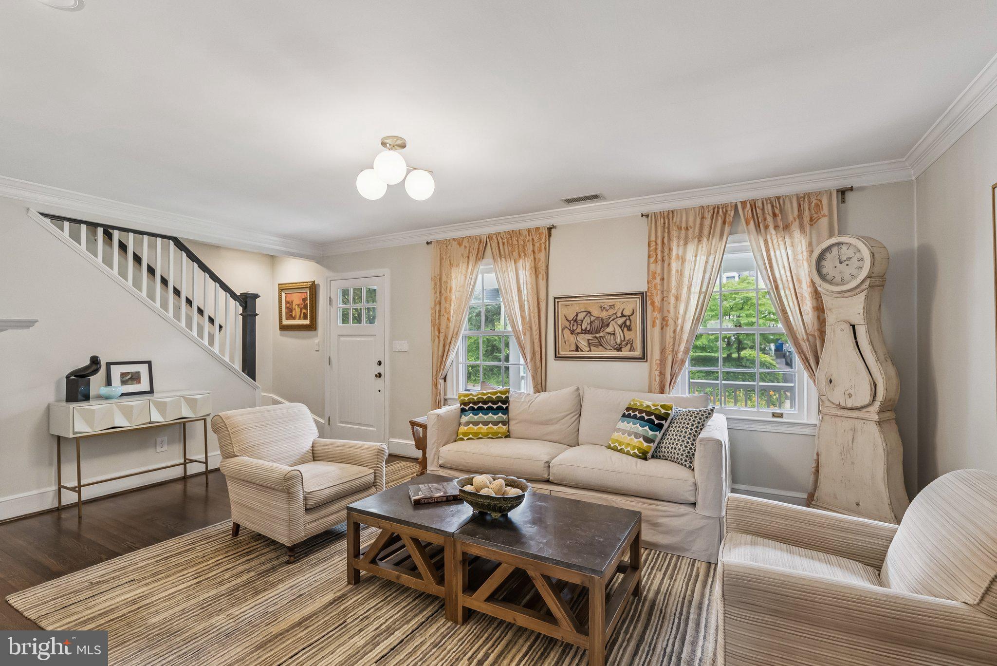 8109 Custer Road Bethesda, MD 20814 - Photo 6 of 54 a living room with furniture a large window and a chandelier