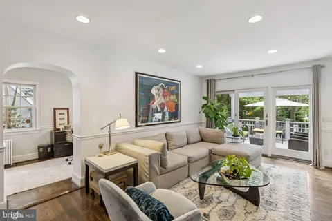 a living room with furniture potted plant and a large window