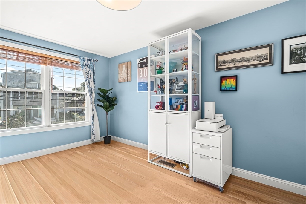 77 Warren Street, Unit A Arlington, MA 02474 - Photo 20 of 34 a view of an empty room with a window and wooden floor