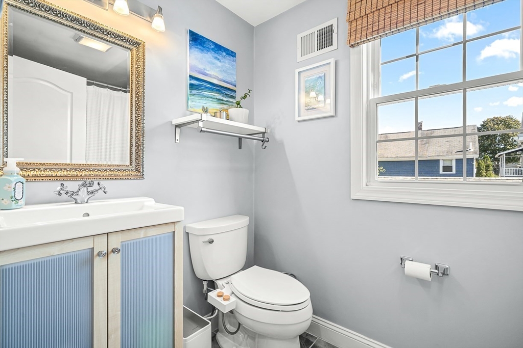 77 Warren Street, Unit A Arlington, MA 02474 - Photo 21 of 34 a bathroom with a toilet a sink and a mirror