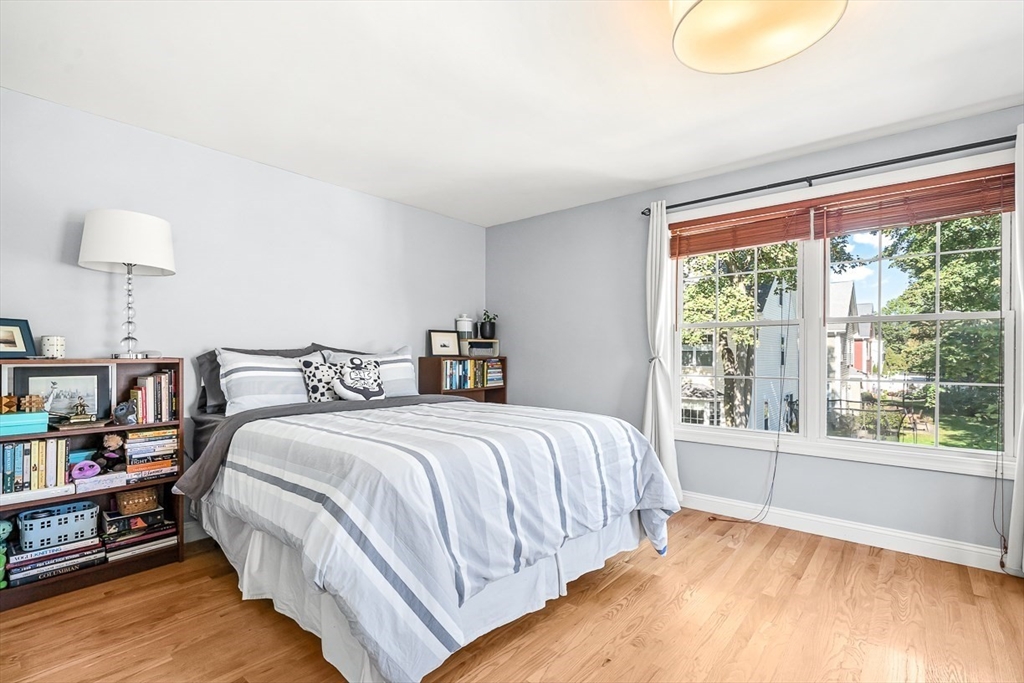 77 Warren Street, Unit A Arlington, MA 02474 - Photo 22 of 34 a bedroom with a bed and a large window