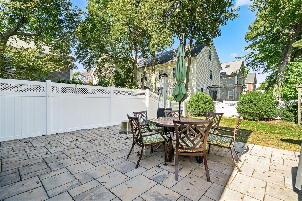 77 Warren Street, Unit A Arlington, MA 02474 - Photo 30 of 34 a view of a patio with table and chairs and potted plants