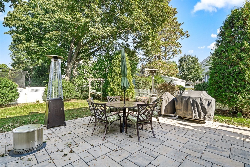 77 Warren Street, Unit A Arlington, MA 02474 - Photo 3 of 34 a view of a patio with table and chairs and potted plants