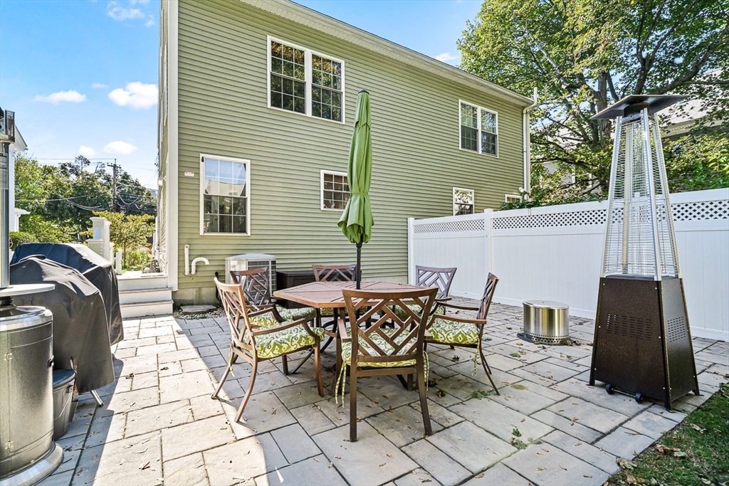 77 Warren Street, Unit A Arlington, MA 02474 - Photo 31 of 34 a view of a patio with a table and chairs