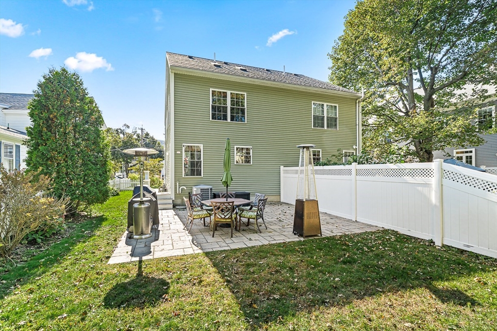 77 Warren Street, Unit A Arlington, MA 02474 - Photo 33 of 34 a front view of a house with a yard