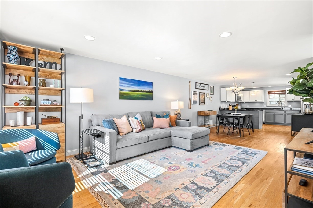 77 Warren Street, Unit A Arlington, MA 02474 - Photo 5 of 34 a living room with furniture and a book shelf