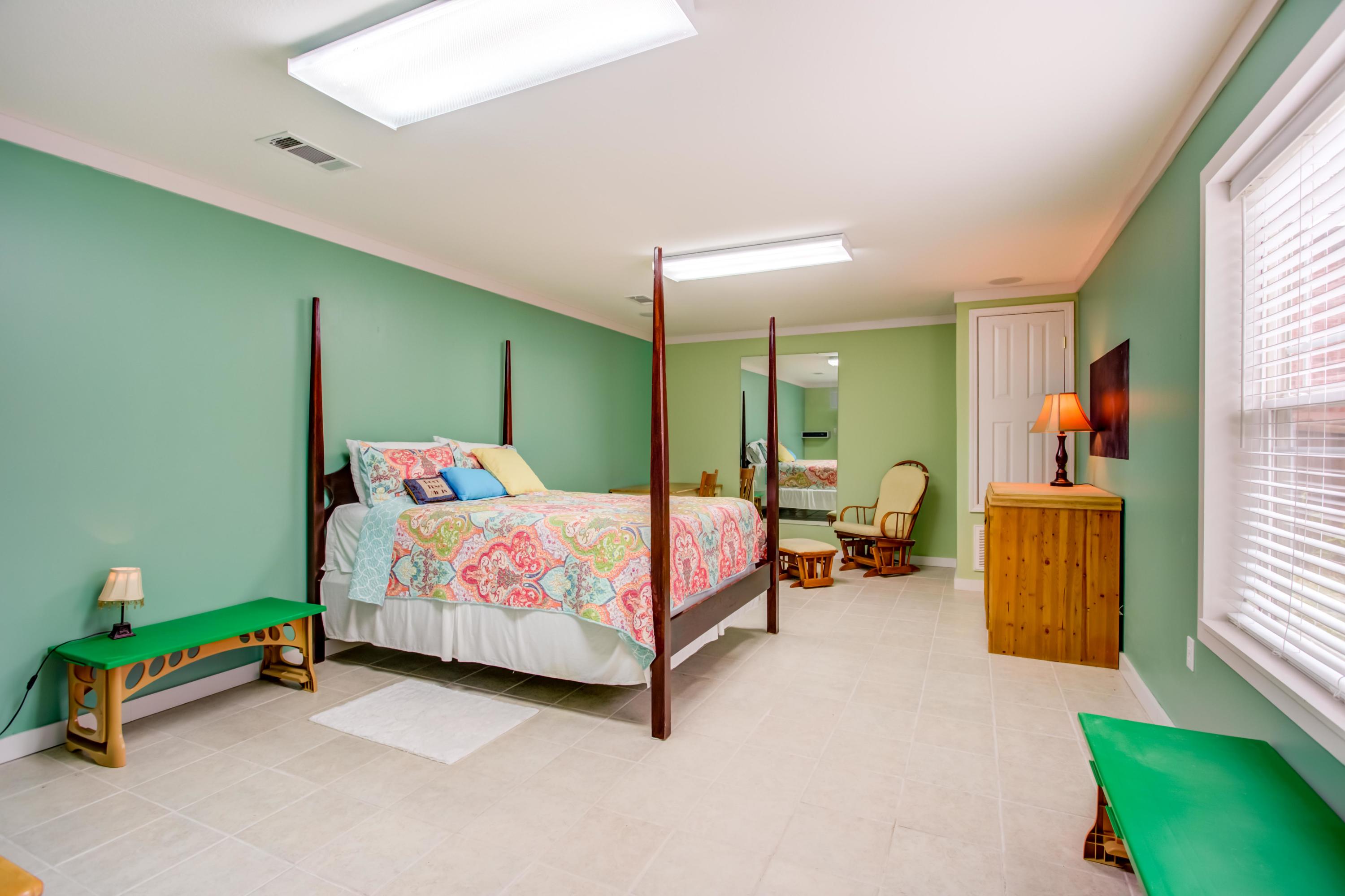 4566 Hermosa Road Crestview, FL 32539 - Photo 33 of 41 a bedroom with a bed and a chandelier