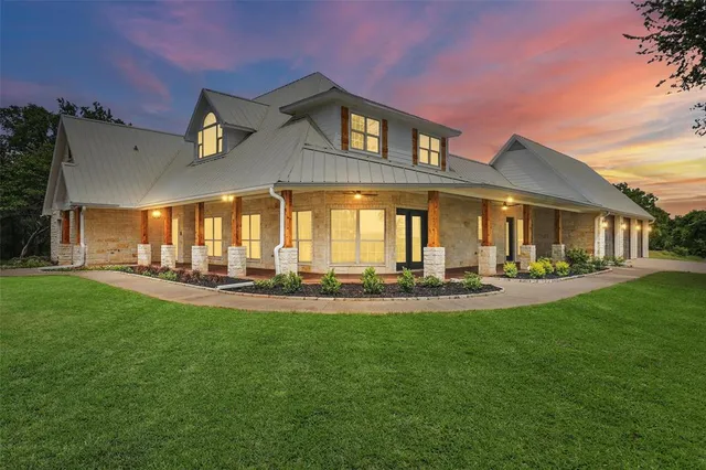 a front view of a house with swimming pool having outdoor seating
