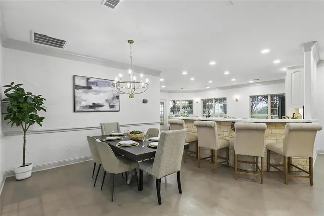a view of a dining room with furniture and chandelier