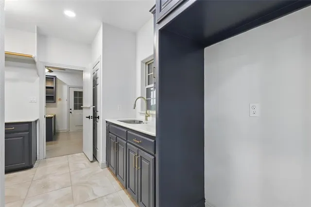 a kitchen with a sink and a refrigerator