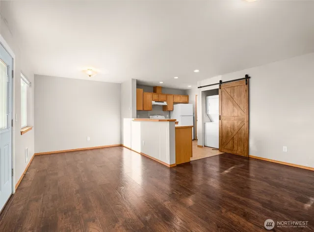 a view of a kitchen with a sink and a refrigerator