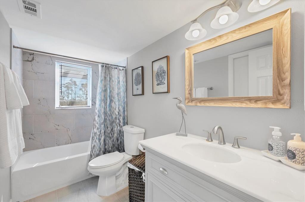 331 Bocilla Drive Boca Grande, FL 33921 - Photo 22 of 34 a bathroom with a toilet a sink a mirror a bath tub and shower